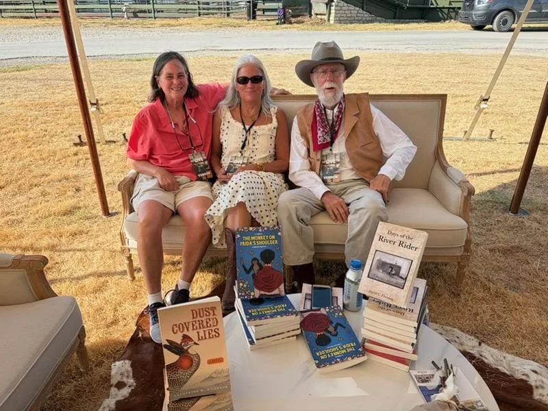 David Layton Fleming at the author table with stacks of Days of the River Rider at Bosque Ranch Live 2026